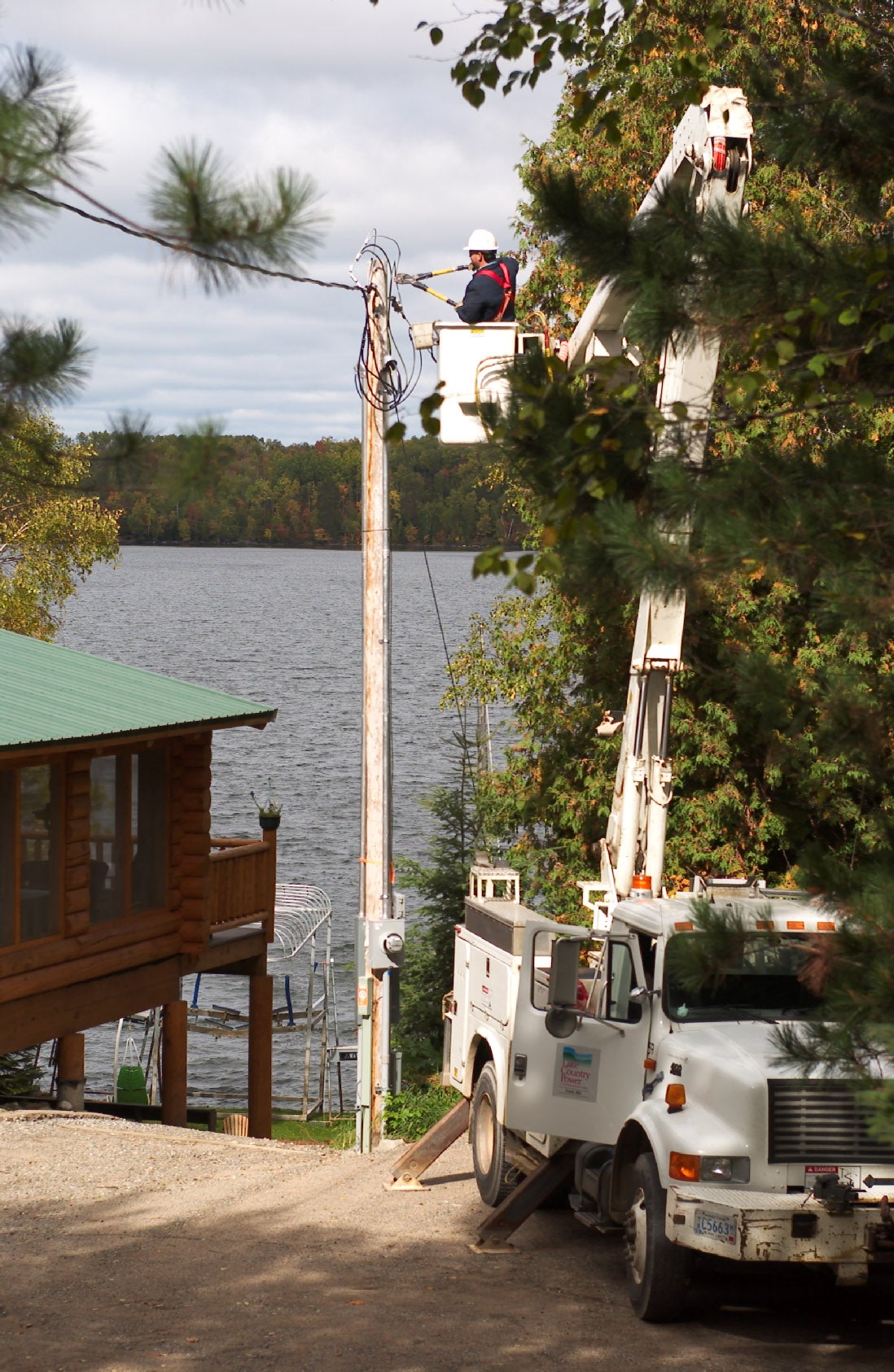 Lineman works on residential power pole