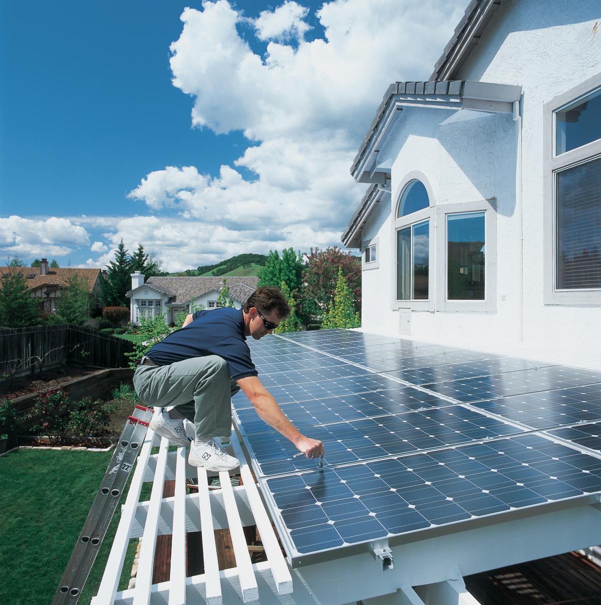 Residential solar installation man on roof